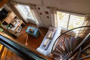 a living room with a white couch and a spiral staircase at Casa Paso de la Patria in Corrientes