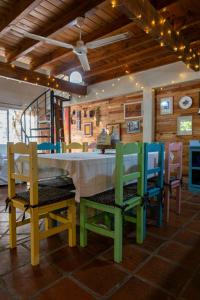 a dining room with colorful chairs and a table at Casa Paso de la Patria in Corrientes +48 photos