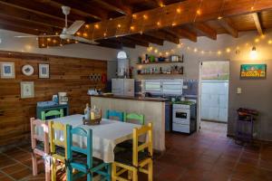 a kitchen with a table and chairs in a room at Casa Paso de la Patria in Corrientes