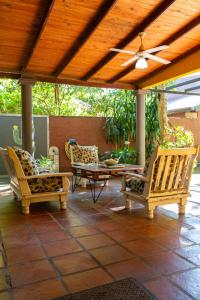 a patio with chairs and a table and a ceiling at Casa Paso de la Patria in Corrientes