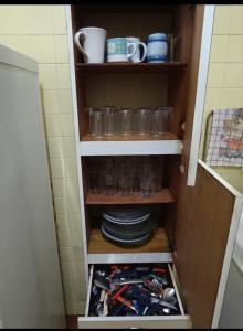 a cupboard filled with lots of wine bottles and glasses at Casa Areal in Araruama +8 photos