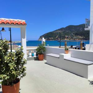 a balcony with a view of the beach at Uncle John's Guesthouse in Skopelos Town