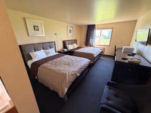 a hotel room with two beds and a window at East Grand Inn Grand Forks ND I 29 in East Grand Forks