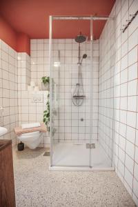 a shower with a glass door in a bathroom at Central Art House Hvar in Hvar