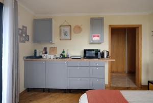 a kitchen with a counter top with a microwave at Bella Vista Studio in Canhas +6 photos