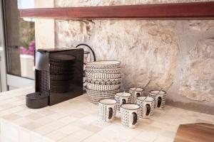 a group of vases sitting on top of a counter at Central Art House Hvar in Hvar