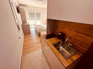 a small kitchen with a sink and a refrigerator at Apartments Kristic in Neum