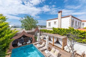 a villa with a swimming pool and a house at NURİYE ALACATI in Alaçatı