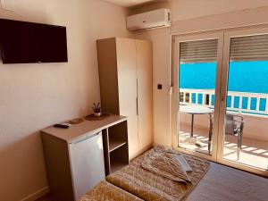 a small room with a kitchen with a view of the ocean at Apartments Kristic in Neum