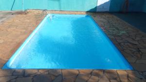 a large blue swimming pool in a house at Edícula Gigá in Brotas