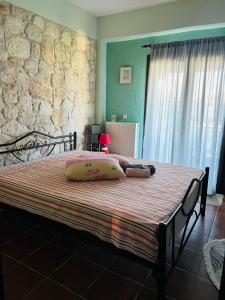 a bed with two pillows on it in a bedroom at Afytos house in Afitos