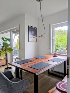 a dining room with a wooden table and chairs at Basislager Rheinsteig in Bad Hönningen