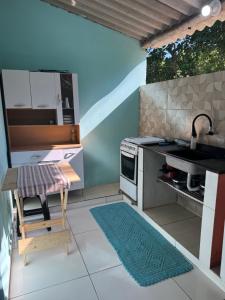 a small kitchen with a sink and a stove at Chalé in Paraty