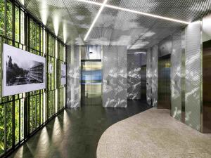 a hallway of a building with glass walls at ibis Almaty Jetisu in Almaty