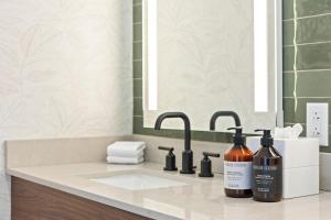 a bathroom with two bottles of soap and a sink at The Wills Hotel in Cumberland