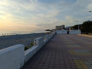 a walkway next to a beach with a building at B&B Fronte mare in Belmonte Calabro