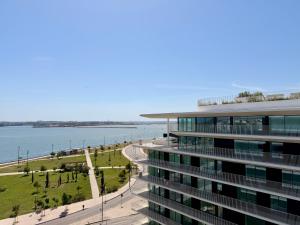 an office building with a view of the water at Nooba Barreiro Apartment in Barreiro