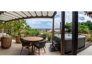 a patio with a table and a bath tub at La Suite Villa in Les Trois-Îlets +40 photos