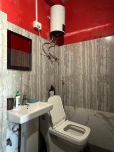 a bathroom with a white toilet and a sink at White Sea Homestay, Dowhill Kurseong in Kurseong +148 photos