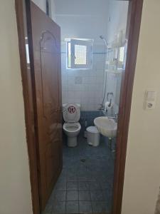 a bathroom with a toilet and a sink at La Casa Tzortzina in Kokkino Nero +28 photos