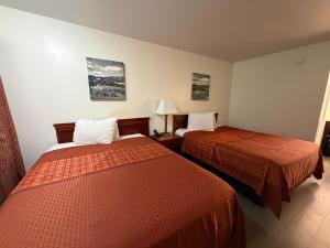 a hotel room with two beds in a room at Travel Inn Buford near Mall of Georgia in Buford