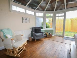 a living room with two chairs and a couch at Bay Cosy in Pevensey