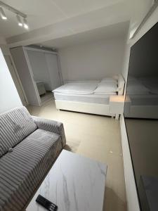 a small room with a bed and a couch at Ana Deluxe Apartment in Radovljica