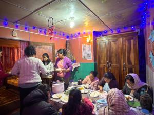 a group of people sitting around a table eating at White Sea Homestay, Dowhill Kurseong in Kurseong