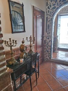 a room with a table and a mirror on the wall at Casa rural las conchas in Cazalla de la Sierra