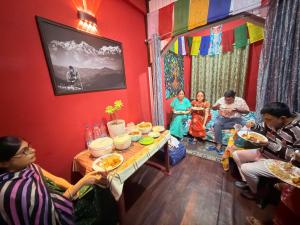 a group of people sitting around a table in a room at White Sea Homestay, Dowhill Kurseong in Kurseong