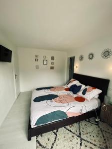 a bedroom with a large bed with a blanket on it at Sabrina in Tarbes