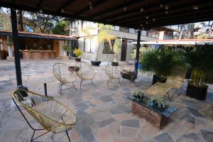 a group of chairs sitting on a patio at Casa Los Agapandos in Valle de Bravo