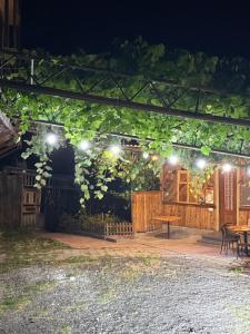 a patio with a table and lights at night at Aygut Garden in Aygut