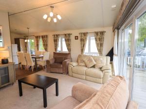a living room with a couch and a table at 41, Grandma's Cottage in Carnforth
