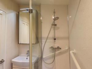 a bathroom with a shower and a toilet and a sink at 41, Grandma's Cottage in Carnforth +27 photos