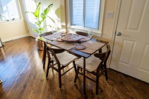 a wooden table with chairs and wine glasses on it at Bucktown Private Condo in Chicago