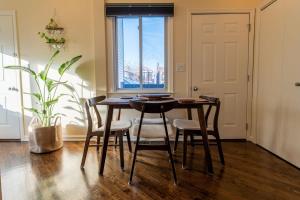a dining room with a table and chairs and a window at Bucktown Private Condo in Chicago