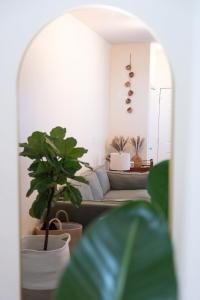 a living room with a couch and potted plants at Bucktown Private Condo in Chicago