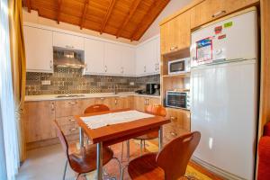 a kitchen with a table and a refrigerator at Villa Masal in Kayakoy