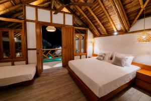 a bedroom with two beds and a window at Boana hotel in Palomino