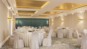 a ballroom with white tables and white chairs at InterContinental Rome Ambasciatori Palace by IHG in Rome