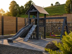 a playground with a slide and a slope at Derevo House in Yasinya