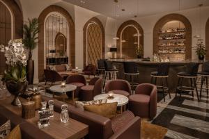 a lobby with a bar and tables and chairs at InterContinental Rome Ambasciatori Palace by IHG in Rome