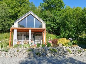 a tiny house on a rock in a garden at Nad Strumieniem in Pieszyce