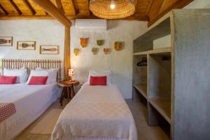 a bedroom with two beds in a room at Casa Caroá - Chalé 1 in Japaratinga +80 photos