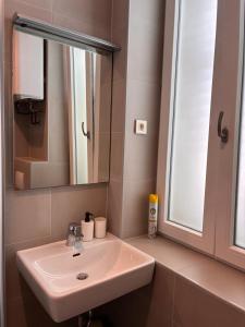 a bathroom with a sink and a mirror at Ridzak Riva Rooms in Mali Lošinj
