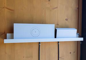 a white laptop sitting on a shelf against a wooden wall at Jazine BeachVilla5 in Tisno