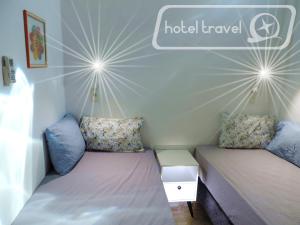 a room with two beds and a sign that reads hotel travel at Hotel Travel Encarnación in Encarnación