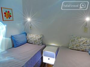a room with two beds in a room at Hotel Travel Encarnación in Encarnación +6 photos