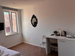 a room with a table and a mirror on the wall at Ridzak Riva Rooms in Mali Lošinj +31 photos